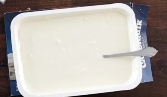 tray of melted white chocolate with spoon.