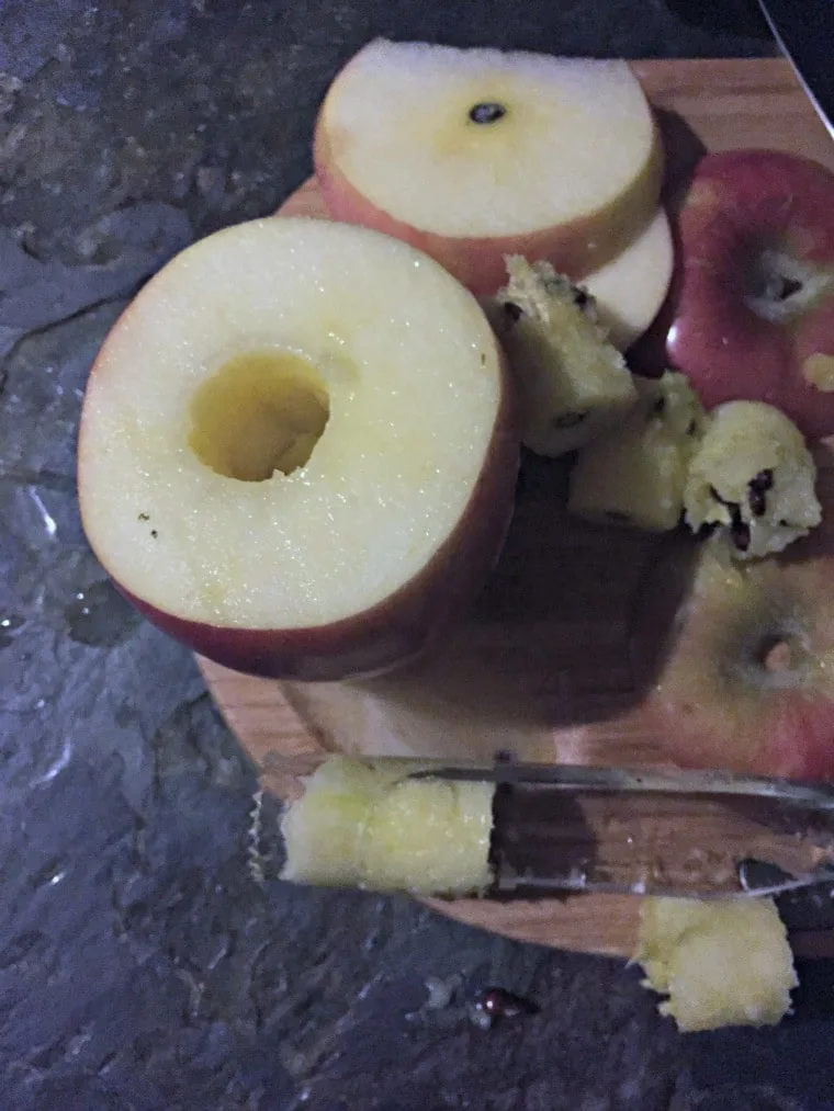 apple on cutting board with the core removed.
