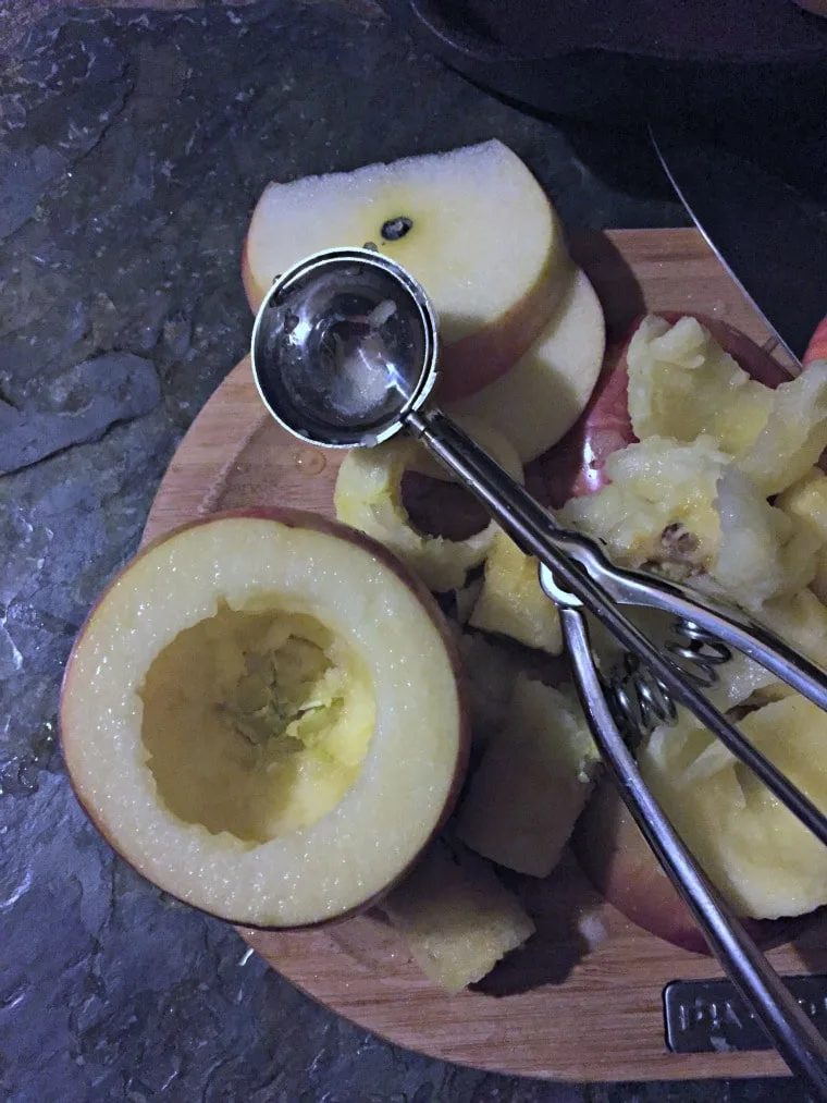 apple on cutting board with scoop 