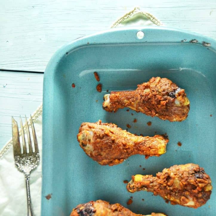 blue dish with chicken legs and a fork