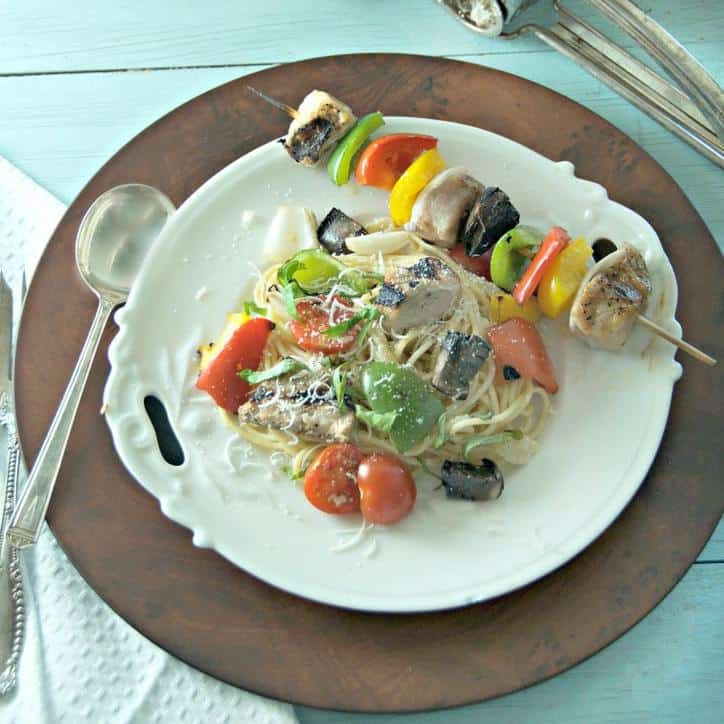 Kabob and pasta on a white plate for how to cut an onion for kabobs