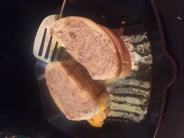 Two grilled chocolate cheese sandwiches in a frying pan