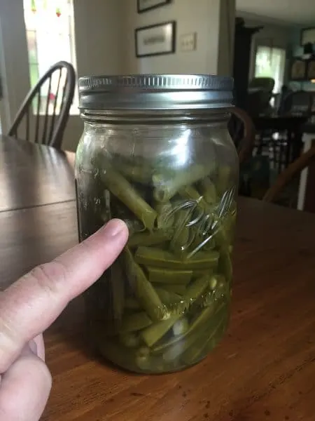 IF the lid is too loose - then the water will siphon from the jar at the end of canning - my finger is pointing to the water line in the jar.