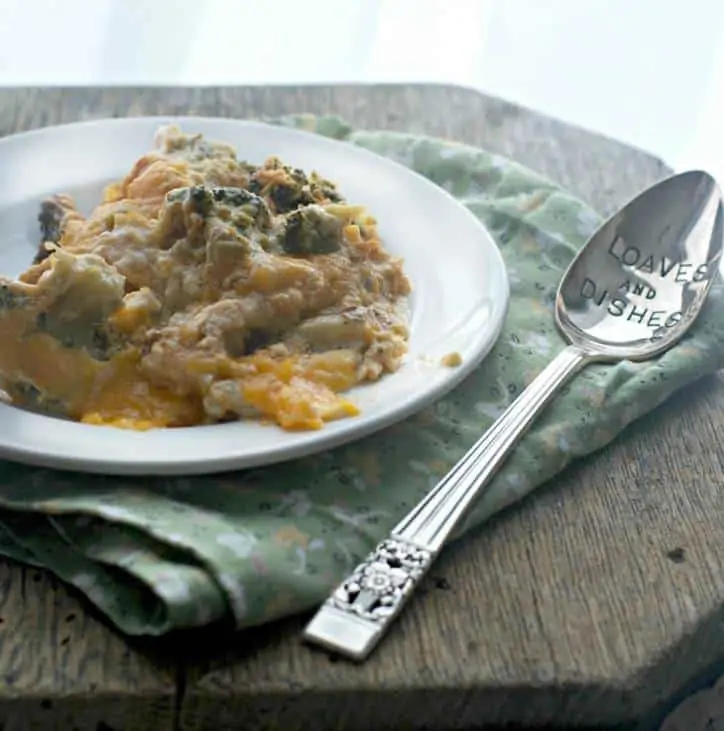 A plate of casserole with green napkin and spoon