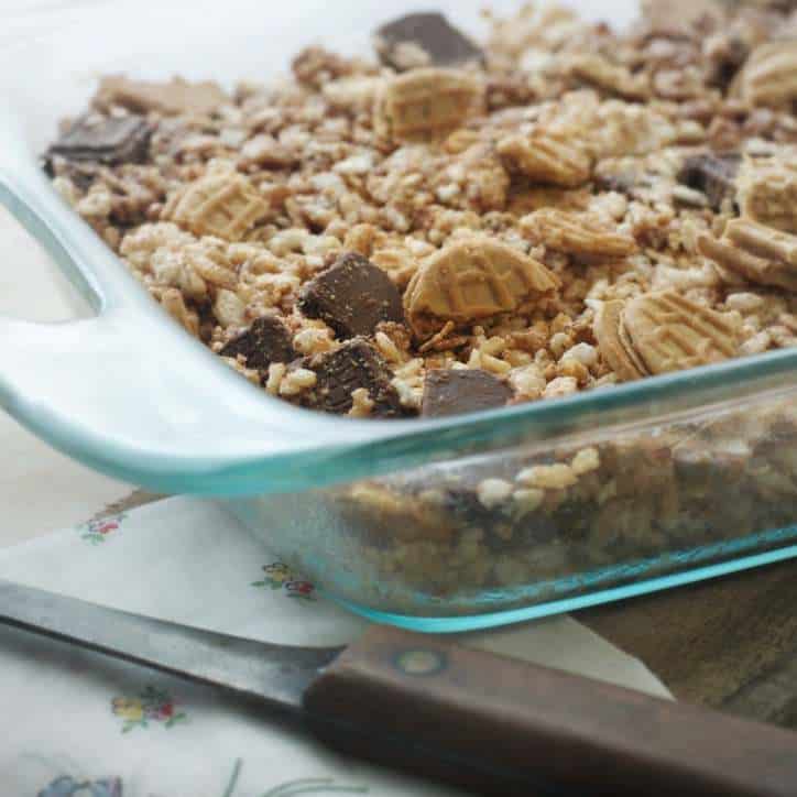 A close up photo of a glass pan with Chocolate Nutter Butter Crispy Treats in it!