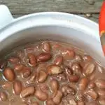 A close up of the pinto beans in a dutch oven showing the pot liquor