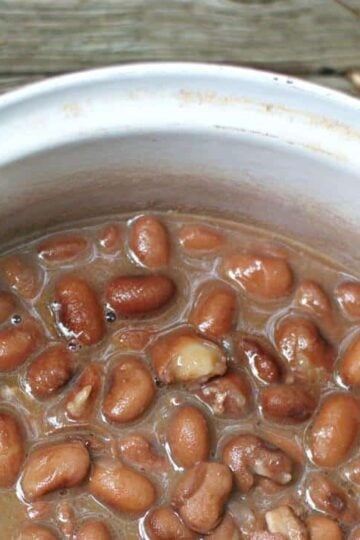 A close up of the pinto beans in a dutch oven showing the pot liquor