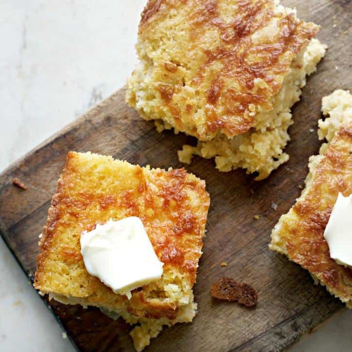 Southern Mexican Cornbread on a cutting board with butter on top