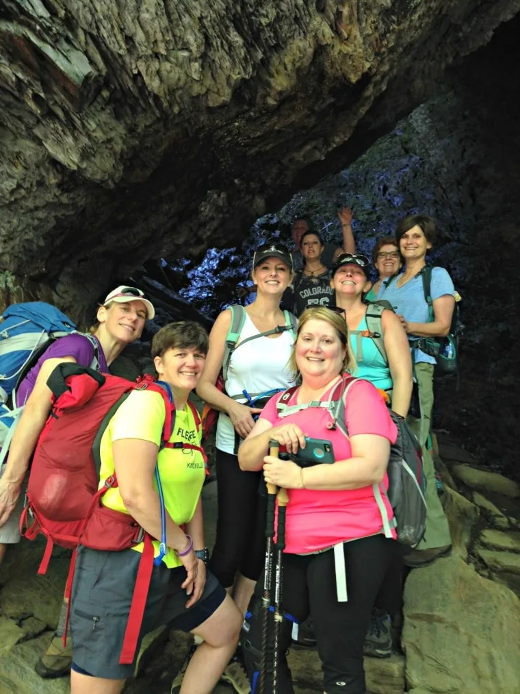 A photo of the author and her friends standing in a cave at the beginning of the hike to the top of Mt. LeConte