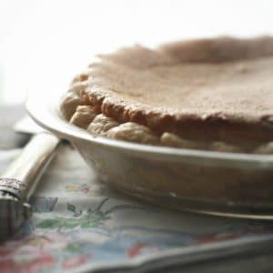 A different shot of the whole pie from the side with morning light in the background for the Old Fashioned Chess Pie