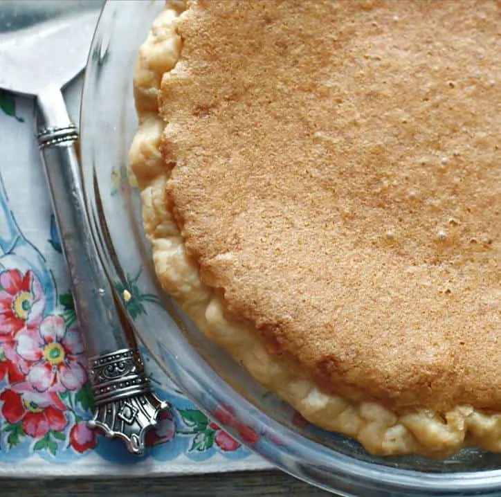 A photo from above of Old Fashioned Chess Pie with about 2/3 showing and the handle of the serving piece