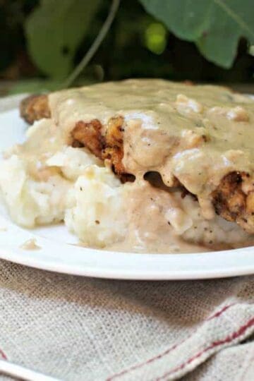 A photo of the side of the The Secret to Perfect Chicken Fried Steak with the gravy dripping down