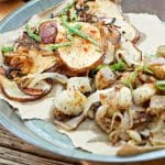 A very close up photo from above of the chip sliced Southern Fried Potatoes and Onions