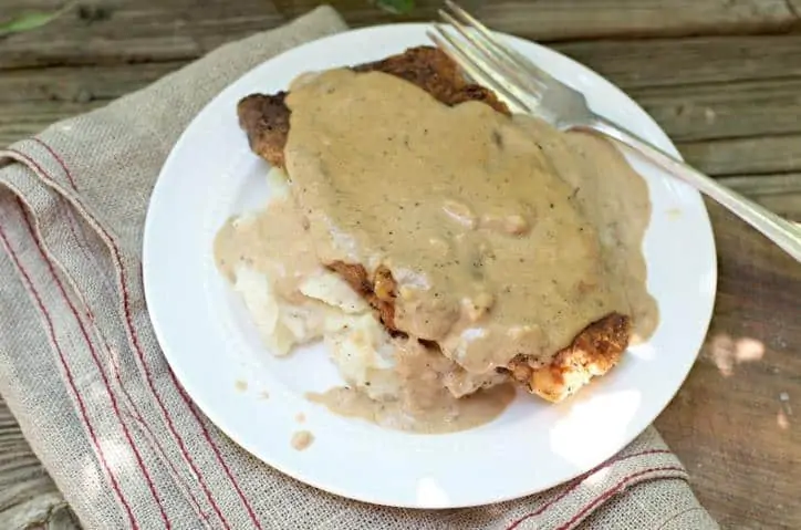 An overhead view of The Secret to Perfect Chicken Fried Steak with the fork in the upper left corner