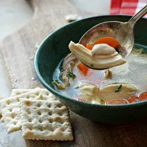 A photo of a spoonful of chicken meat in THE SECRET TO THE BEST CHICKEN SOUP