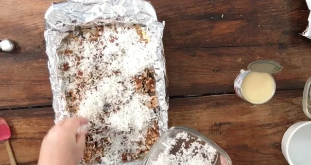 Sprinkling coconut flakes over the top of the other ingredients