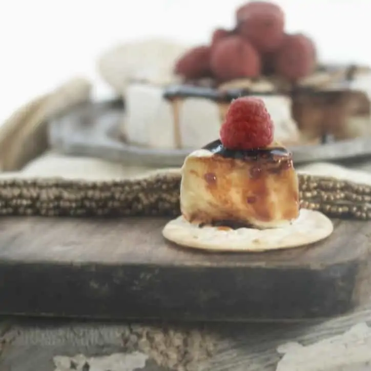 One slice removed from the Toasted Almond Raspberry Baked Brie