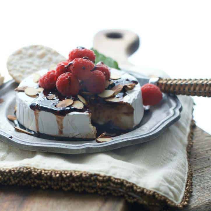 A photo of Toasted Almond Raspberry Baked Brie in fading sunlight