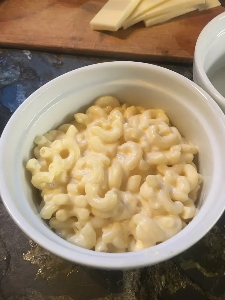 A ramekin half filled with mac and cheese