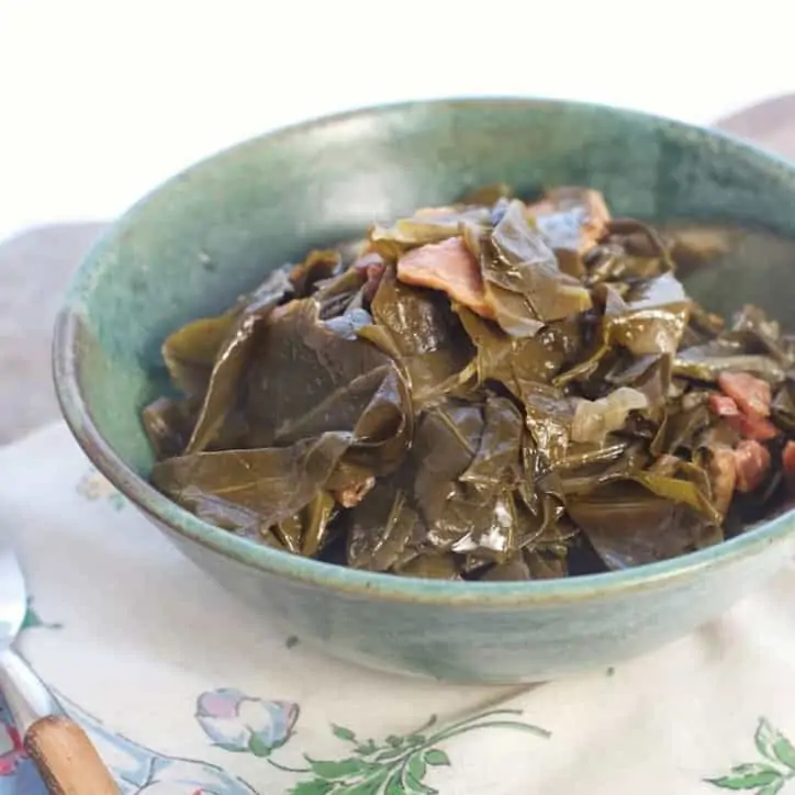 A bowl of greens from the side view of THE SECRET TO PERFECT SOUTHERN COLLARD GREENS