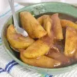 A photo of a bowl of fried apples with a spoon THE SECRET TO PERFECT SOUTHERN FRIED APPLES