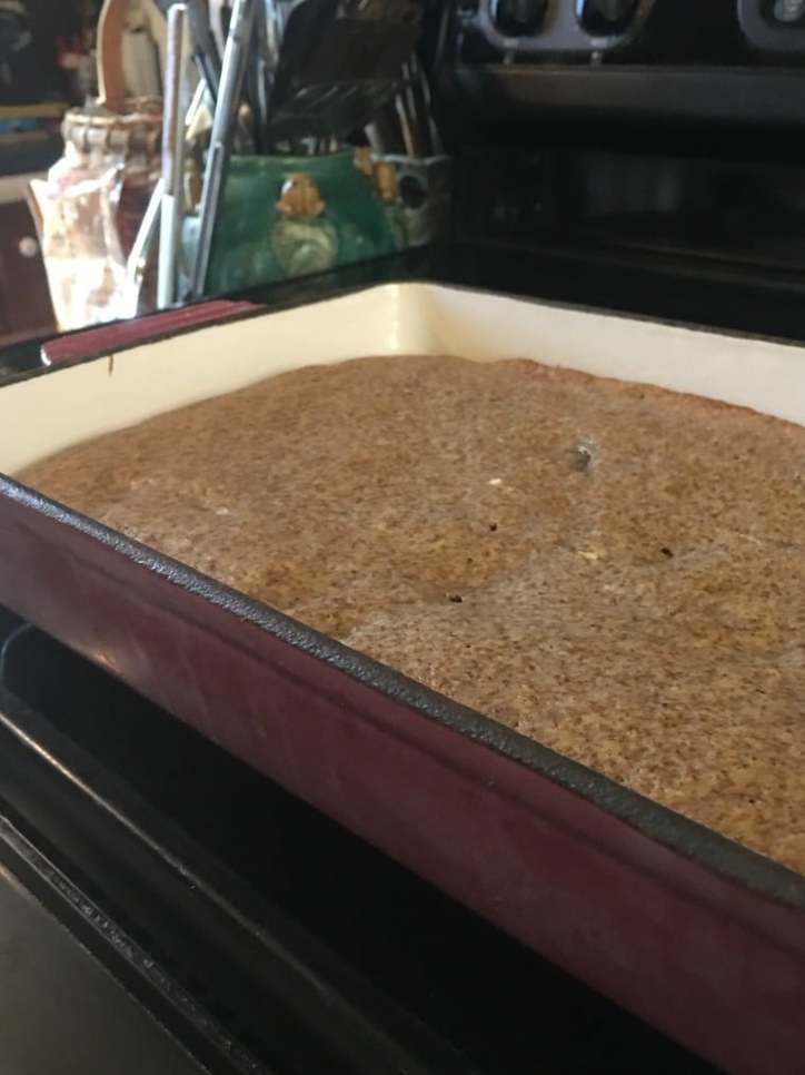 The rustic looking cake sitting on the stove top. Fried Apple Cake with Caramel Icing