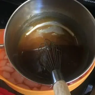 A photo of the icing cooling in an ice bath Fried Apple Cake with Caramel Icing