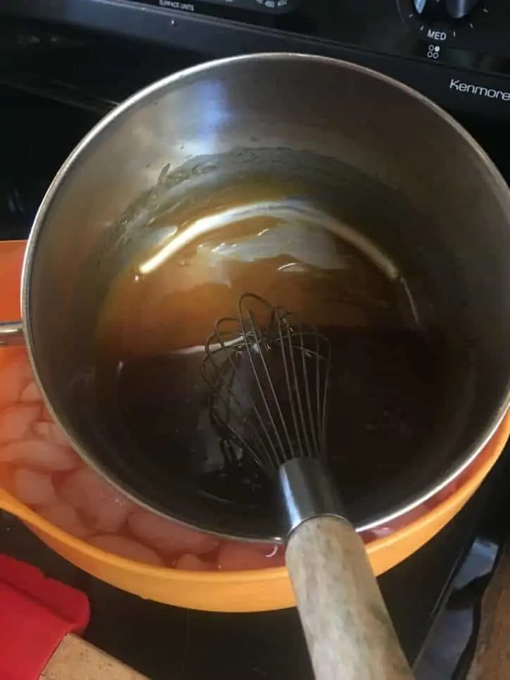 A photo of the icing cooling in an ice bath Fried Apple Cake with Caramel Icing