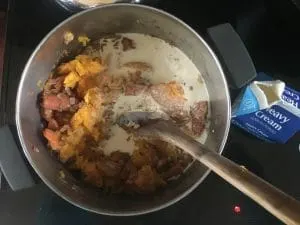 A photo of the stock pot with the squash meat added to the soup. Roasted Butternut Squash Soup