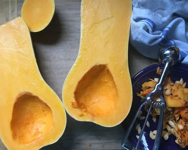 A photo of the insides of the squash with the seeds scooped out for Roasted Butternut Squash Soup