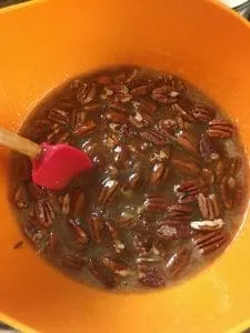 A photo of gently mixing in the pecans for the Kentucky Bourbon Pie