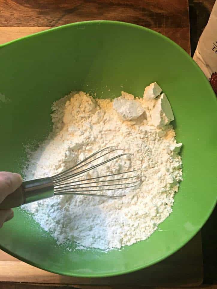 A photo showing the dry ingredients being whisked together for Southern Buttermilk Biscuits
