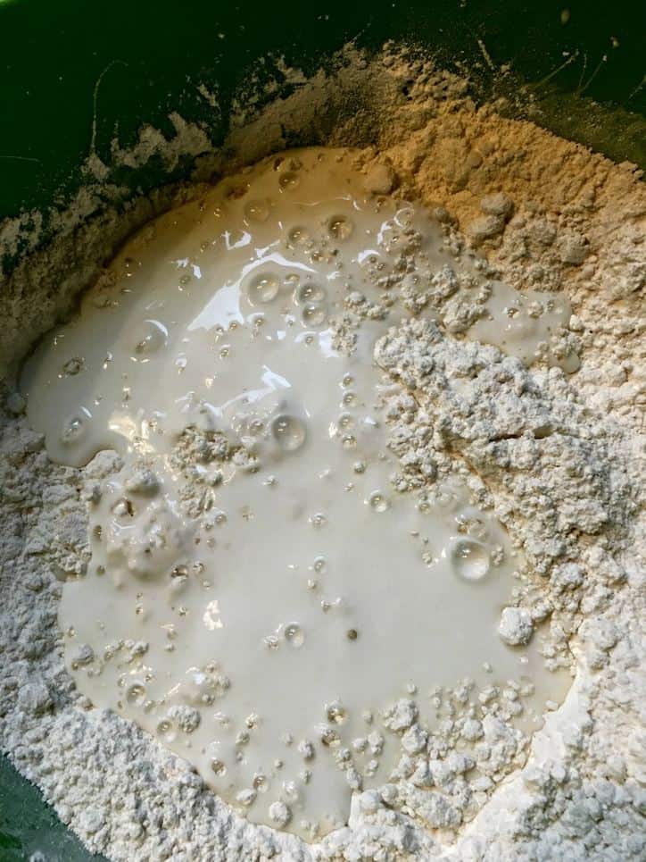 A photo of the buttermilk being added for Southern Buttermilk Biscuits
