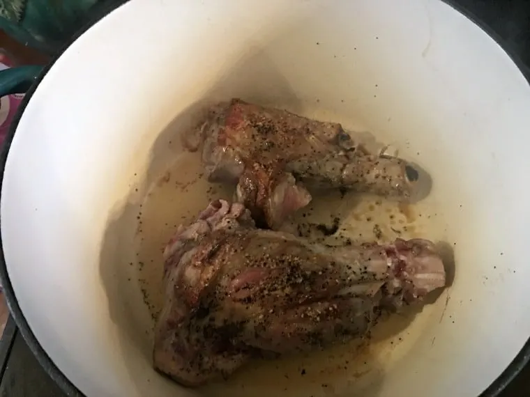 The meat browned on one side in oil in dutch oven