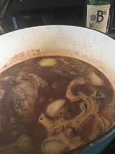 a photo of everything added back to the pot for Lamb Shanks in Wine Sauce