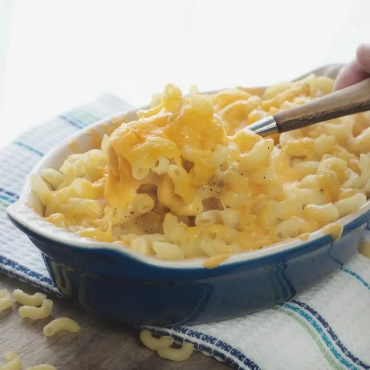 A photo of the macaroni and cheese being scooped from the dish