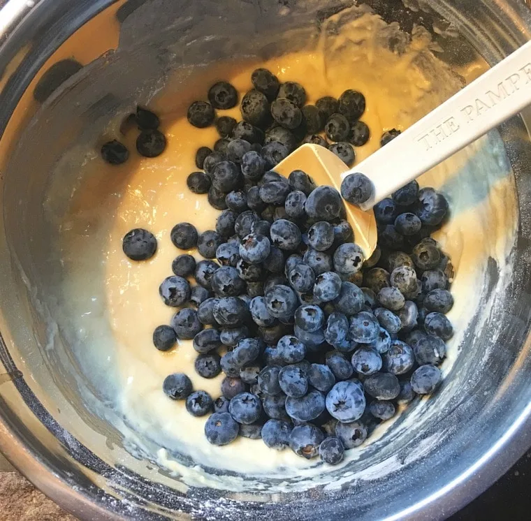 A photo of the blueberries being folded in for BLUEBERRY MUFFINS WITH CRUMBLE TOP