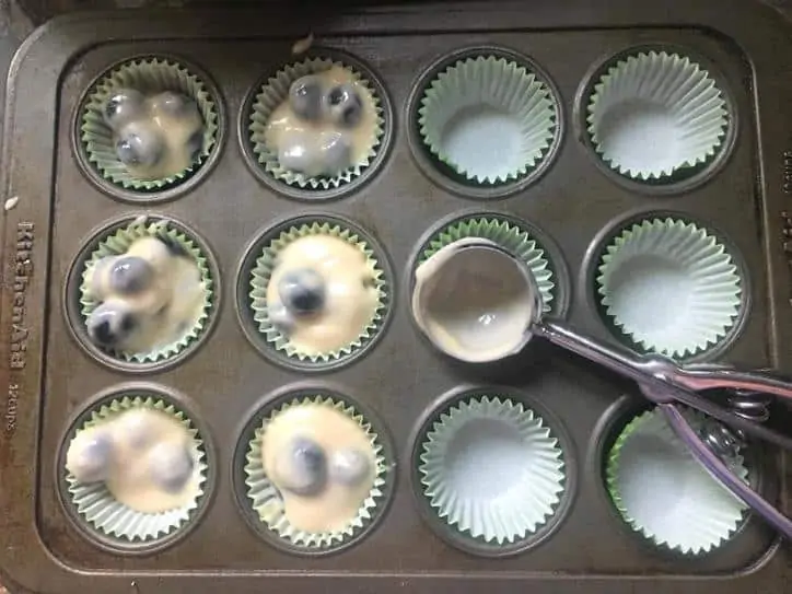 a photo of the batter scooped into the muffin cups for BLUEBERRY MUFFINS WITH CRUMBLE TOP