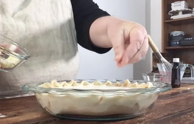 Wendi sprinkling dots of butter around the top of the pie