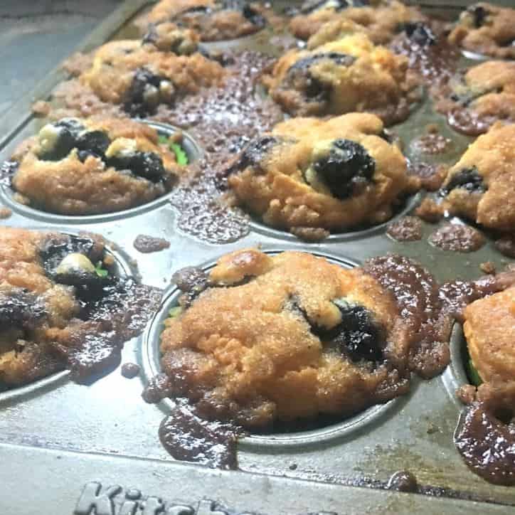 A photo of the baked muffins in the pan for BLUEBERRY MUFFINS WITH CRUMBLE TOP