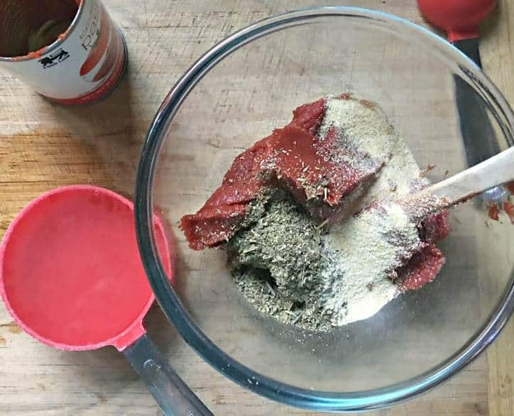 An overhead shot of the ingredients for easy pizza sauce from scratch ready to be mixed up