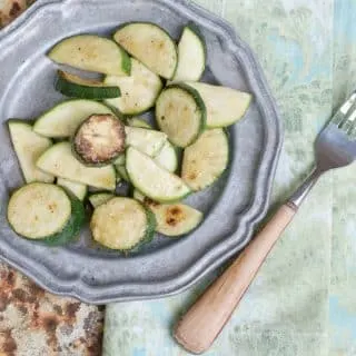 An image from above and to the side of how to cook zucchini on the stove