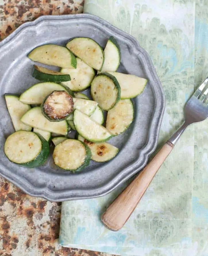 An image from above and to the side of how to cook zucchini on the stove