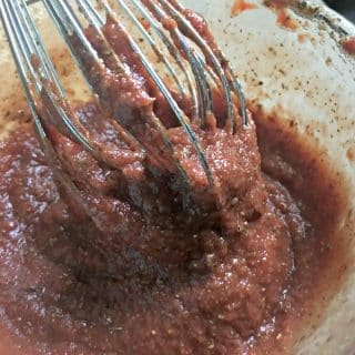 A close up photo of the easy pizza sauce from scratch with the whisk