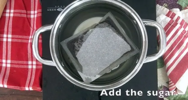 a large family size tea bag floating in sauce pan