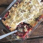 A rectangular pan of easy cherry cobbler with a spoon in it