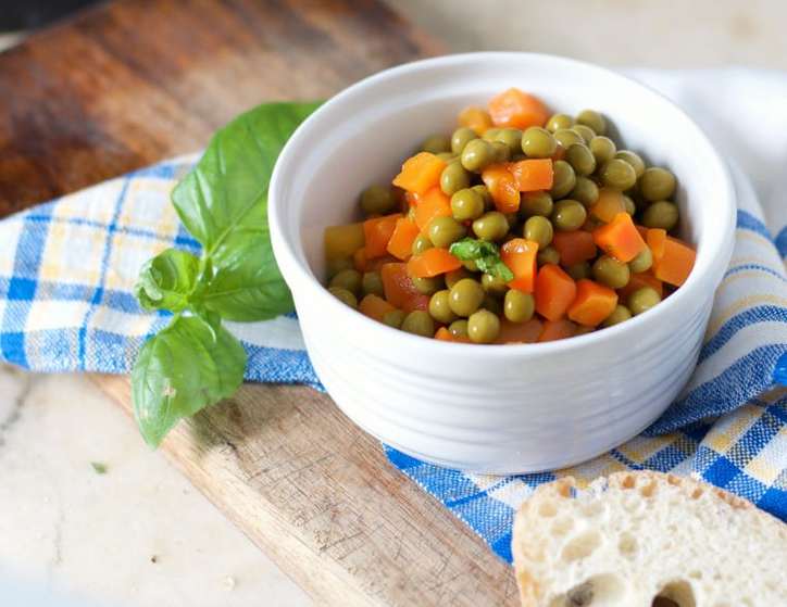 A close up photo from above of HOW TO COOK CANNED PEAS AND CARROTS