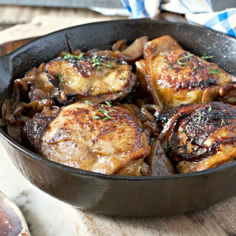 cast iron frying pan of chicken thighs