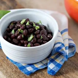 A close up photo of how to cook canned black beans on the stove