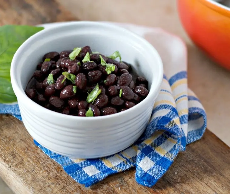 A close up photo of how to cook canned black beans on the stove